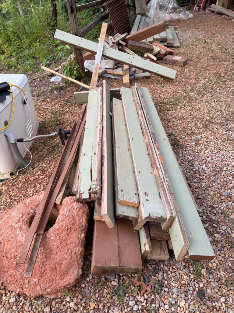BEFORE — A pile of dismantled deck boards, railing pieces, and scrap lumber awaiting removal by Appalachian Junk Removal, LLC in Clayton, Georgia.