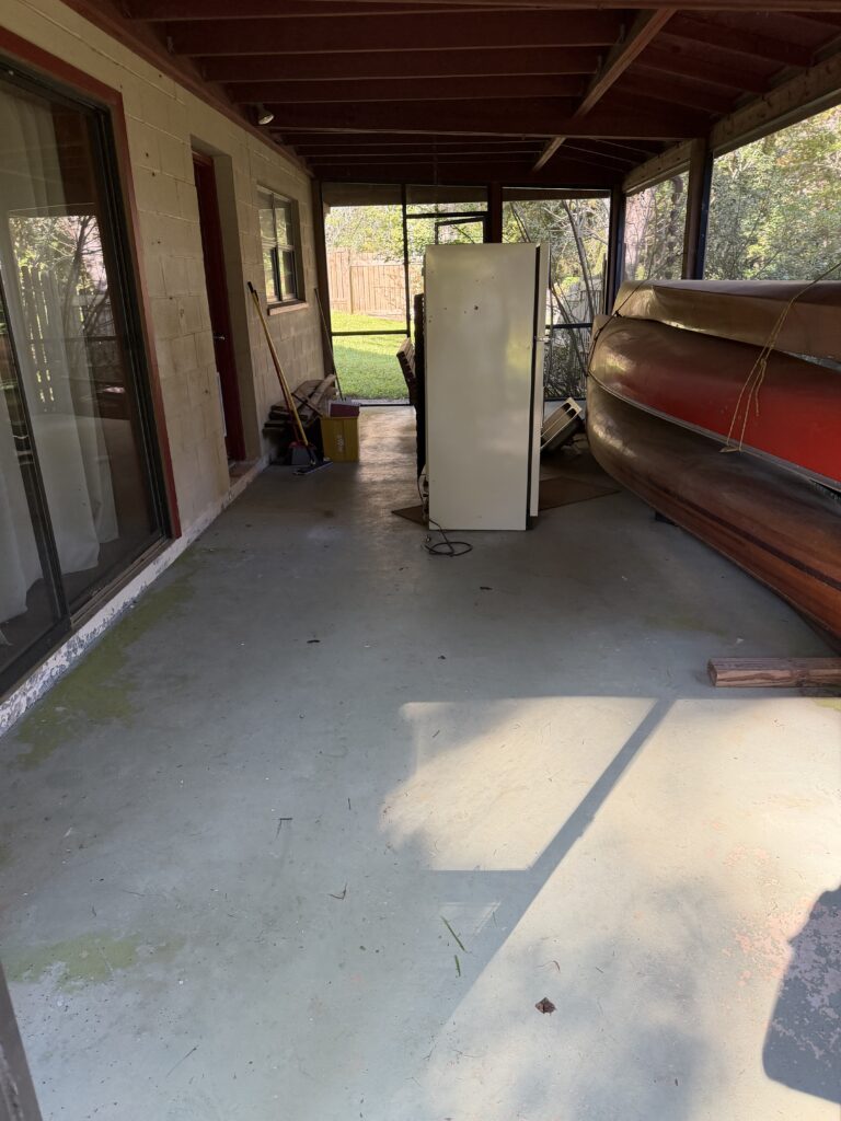 Refrigerator inside a screened porch before appliance removal in Hiawassee, Georgia, by Appalachian Junk Removal, LLC.